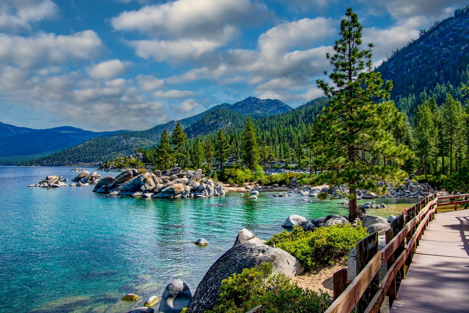 a scenic view of a lake surrounded by mountains